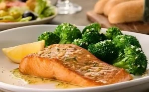 A perfectly cooked herb-grilled salmon fillet served with fresh vegetables